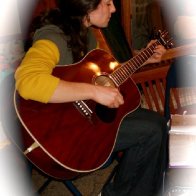 Singing, strumming, visiting Sarah