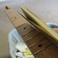 Sanding rough edges on fretboard