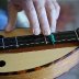 Closeup of Hennessy dulcimer with interesting capo design